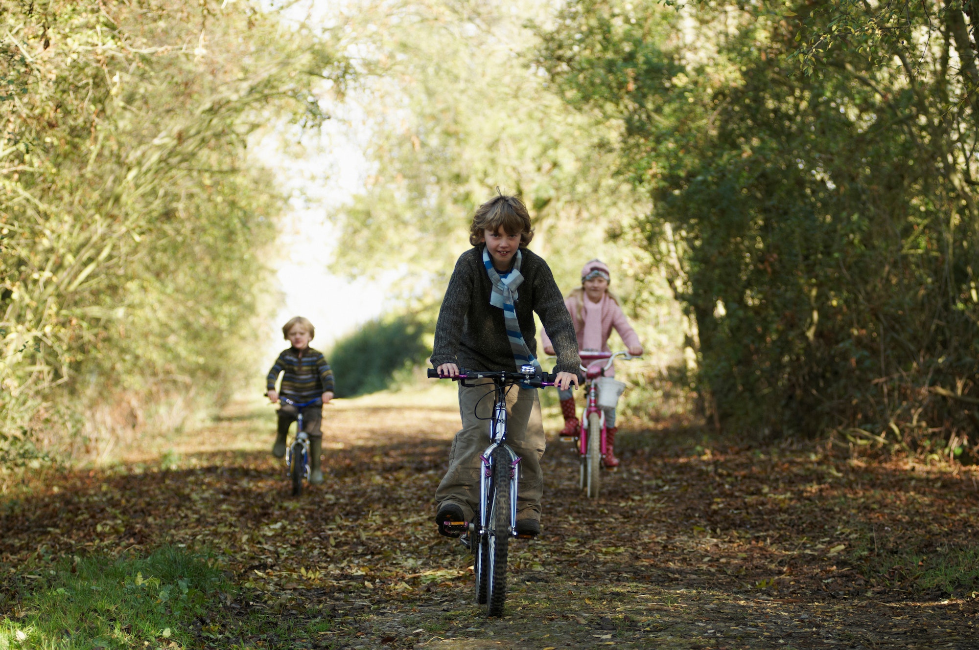 Children riding bikes in countryside